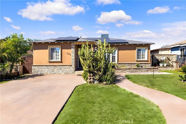 back of house with stone siding, stucco siding, and a gate