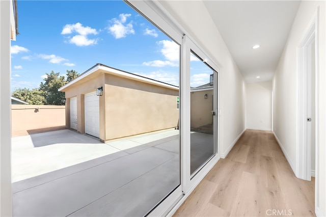 corridor featuring recessed lighting, baseboards, and wood finished floors