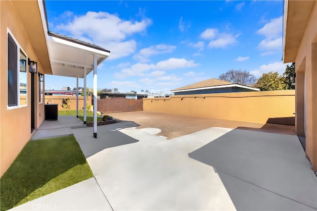 view of patio featuring fence