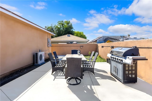 view of patio with ac unit, outdoor dining area, grilling area, and fence