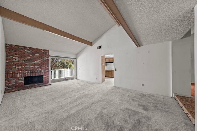 unfurnished living room featuring visible vents, beam ceiling, a fireplace, a textured ceiling, and carpet flooring