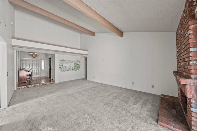 unfurnished living room featuring beamed ceiling, carpet floors, a textured ceiling, and a notable chandelier