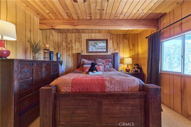 carpeted bedroom with wood walls, wooden ceiling, and beam ceiling