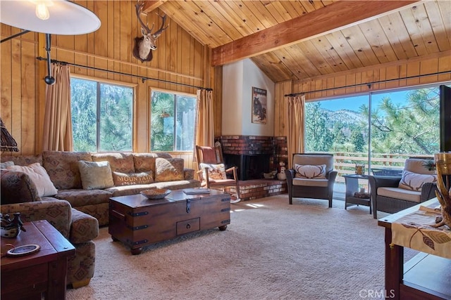 living area with wooden walls, a brick fireplace, beam ceiling, carpet flooring, and wooden ceiling