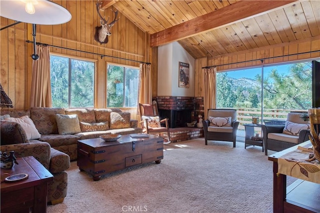 living area featuring carpet flooring, wood walls, a fireplace, beam ceiling, and wood ceiling