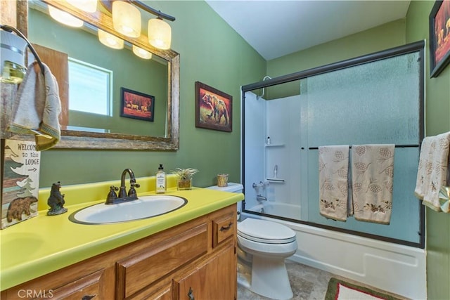 full bathroom featuring toilet, shower / bath combination with glass door, and vanity