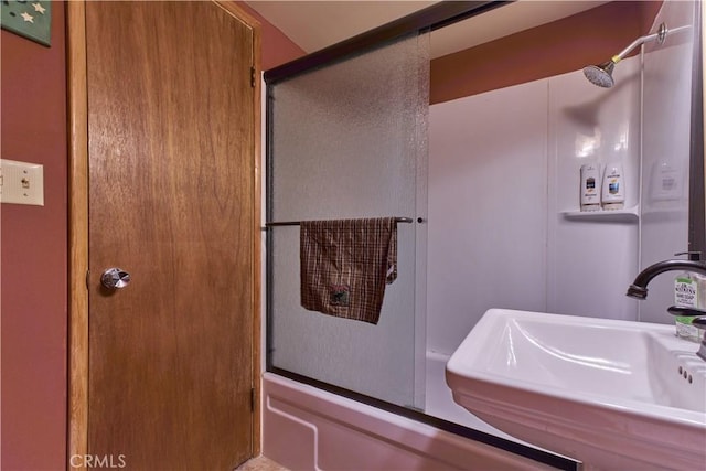 full bath with an enclosed shower and a sink