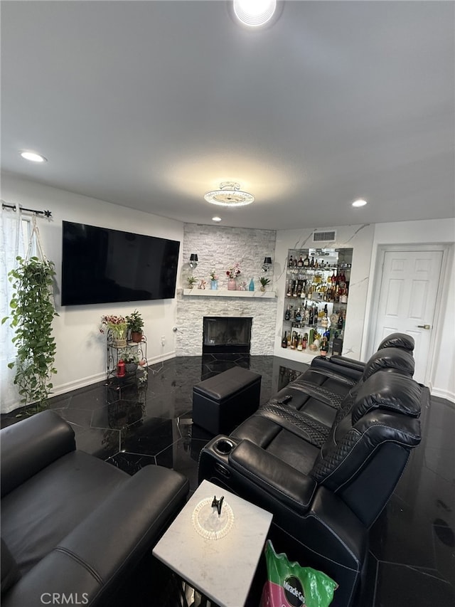 living room with recessed lighting, visible vents, and a fireplace