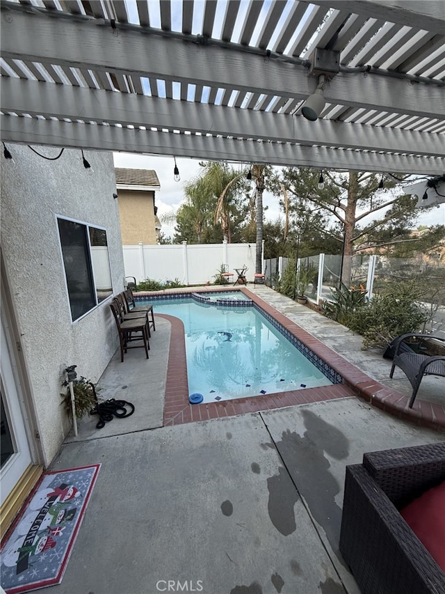 view of pool featuring a patio area, a fenced backyard, a pergola, and a pool with connected hot tub