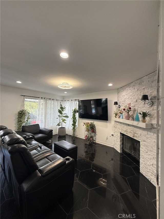 living room featuring recessed lighting, marble finish floor, and a fireplace