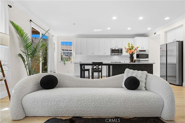 living area featuring recessed lighting, light wood finished floors, and ornamental molding