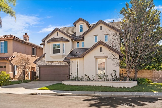 townhome / multi-family property with stucco siding, driveway, fence, an attached garage, and a tiled roof