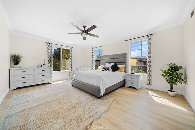 bedroom featuring visible vents, crown molding, ceiling fan, baseboards, and light wood-type flooring