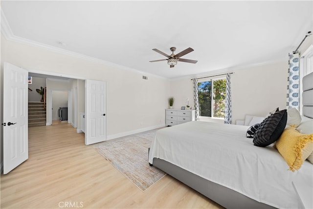 bedroom featuring light wood-style flooring, crown molding, baseboards, and ceiling fan