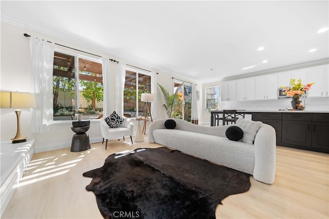 bedroom with light wood finished floors, recessed lighting, baseboards, and ornamental molding