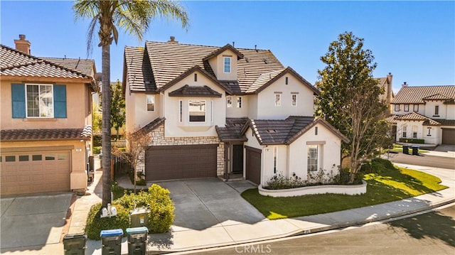 view of front of home featuring an attached garage, stone siding, driveway, and stucco siding