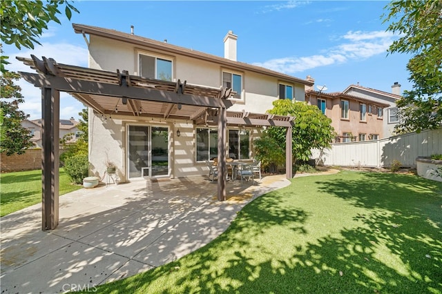 back of property with stucco siding, a lawn, a fenced backyard, and a pergola