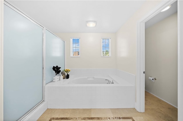 bathroom with tile patterned floors, a stall shower, and a bath