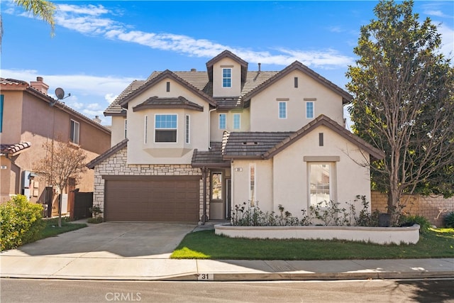 view of front of home with a tiled roof, concrete driveway, stucco siding, stone siding, and an attached garage