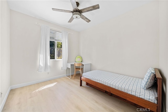 bedroom with ceiling fan, baseboards, and wood finished floors