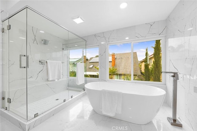 full bathroom featuring marble finish floor and stone wall