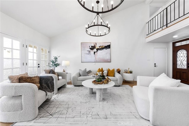 living room with a chandelier, french doors, and high vaulted ceiling