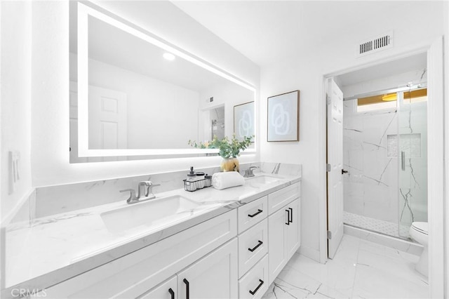 full bath featuring a marble finish shower, visible vents, marble finish floor, and a sink