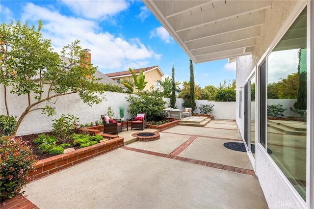 view of patio / terrace featuring a fire pit and a fenced backyard