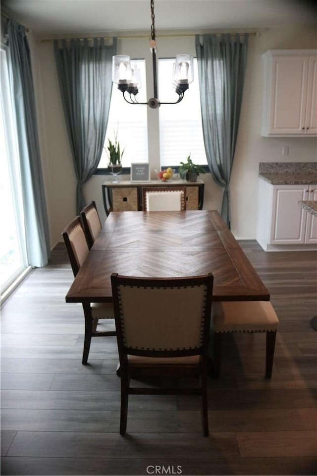 dining room featuring an inviting chandelier and wood finished floors