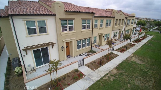 view of front of home with a tiled roof and stucco siding