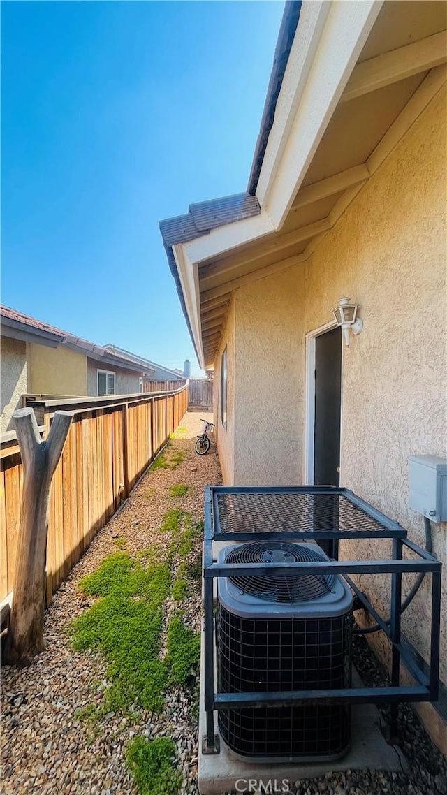 view of yard with cooling unit and fence