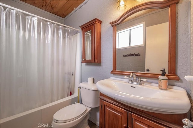 full bathroom with shower / tub combo, toilet, vanity, and a textured wall