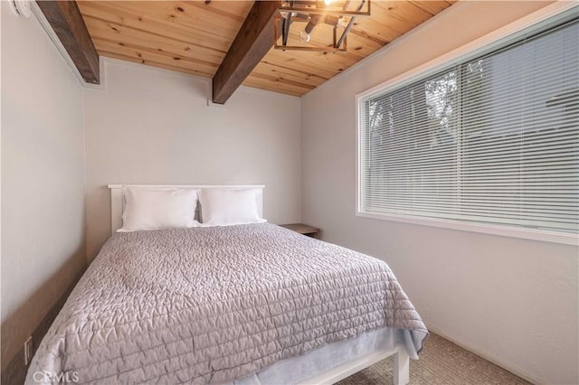 carpeted bedroom with wooden ceiling and beam ceiling