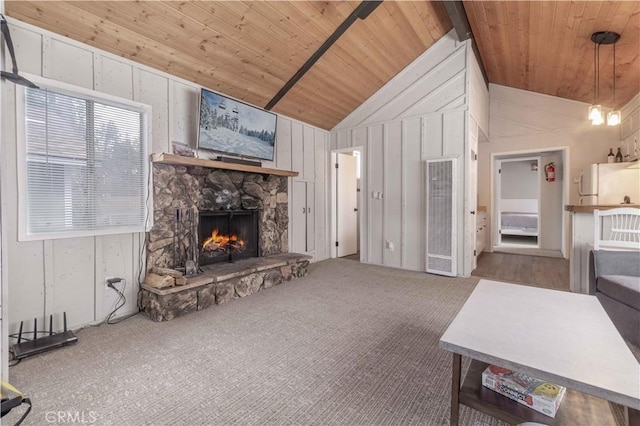 living room with a stone fireplace, wooden ceiling, carpet floors, and vaulted ceiling