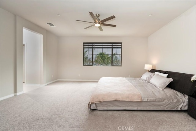 carpeted bedroom with baseboards, visible vents, and ceiling fan