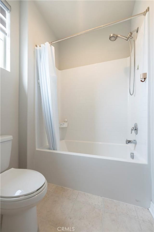 full bathroom featuring tile patterned floors, shower / bath combination with curtain, and toilet