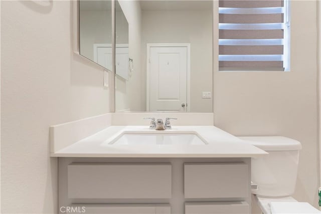 half bath with vanity and toilet