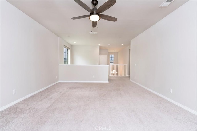 carpeted spare room with visible vents, recessed lighting, a ceiling fan, and baseboards