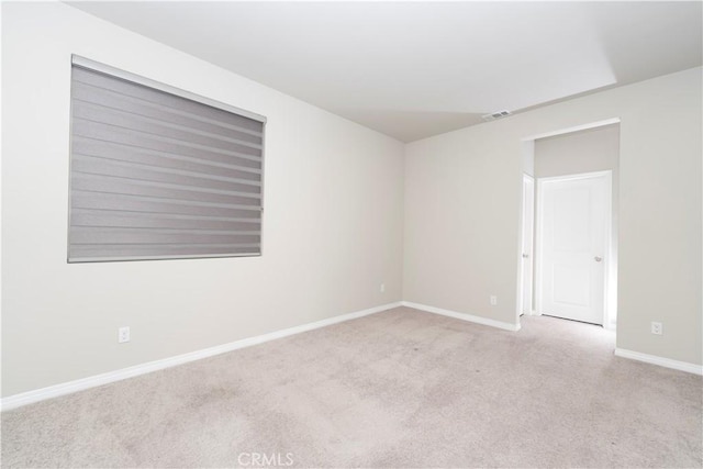 carpeted empty room with baseboards and visible vents