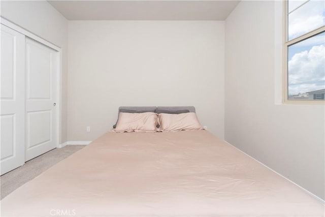 carpeted bedroom with a closet