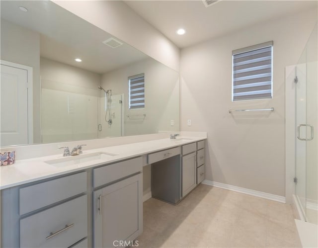 full bathroom featuring visible vents, a shower stall, double vanity, recessed lighting, and a sink