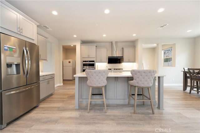 kitchen featuring visible vents, light wood finished floors, recessed lighting, stainless steel appliances, and light countertops