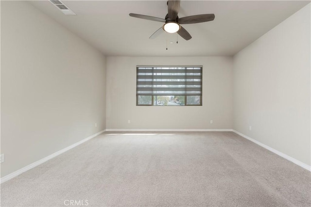 unfurnished room featuring visible vents, baseboards, carpet, and a ceiling fan