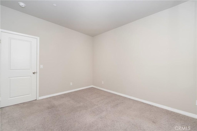 empty room with carpet flooring and baseboards