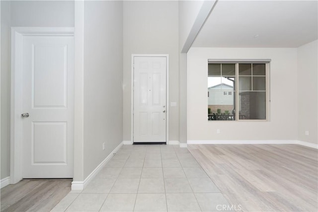 spare room with light wood-style flooring and baseboards