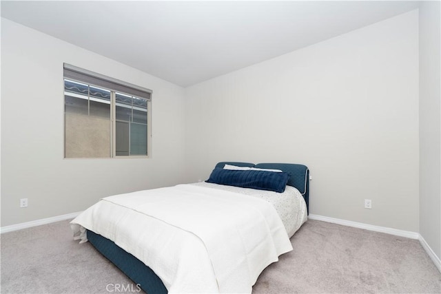 bedroom with carpet flooring and baseboards