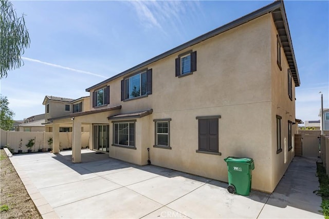 back of house with a patio, a fenced backyard, and stucco siding