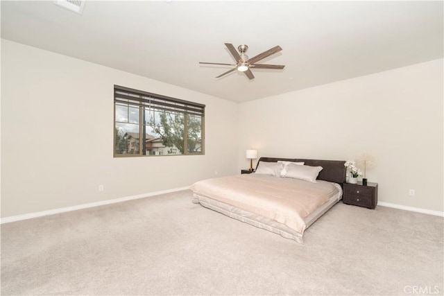 carpeted bedroom featuring visible vents, a ceiling fan, and baseboards