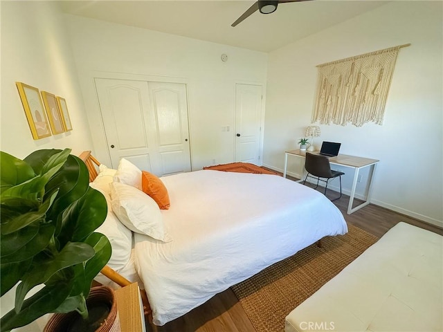 bedroom with a closet, a ceiling fan, baseboards, and wood finished floors