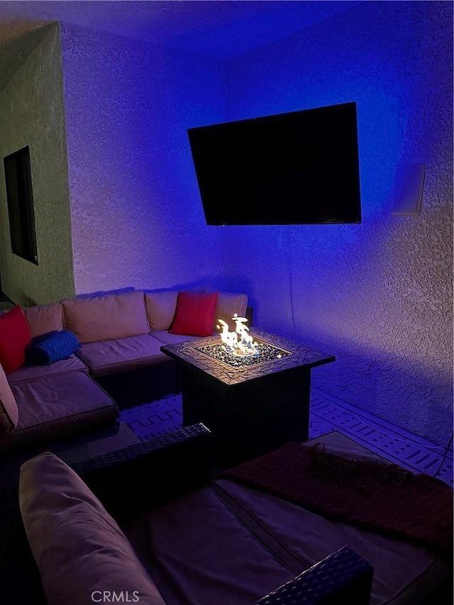 home theater room featuring a textured wall